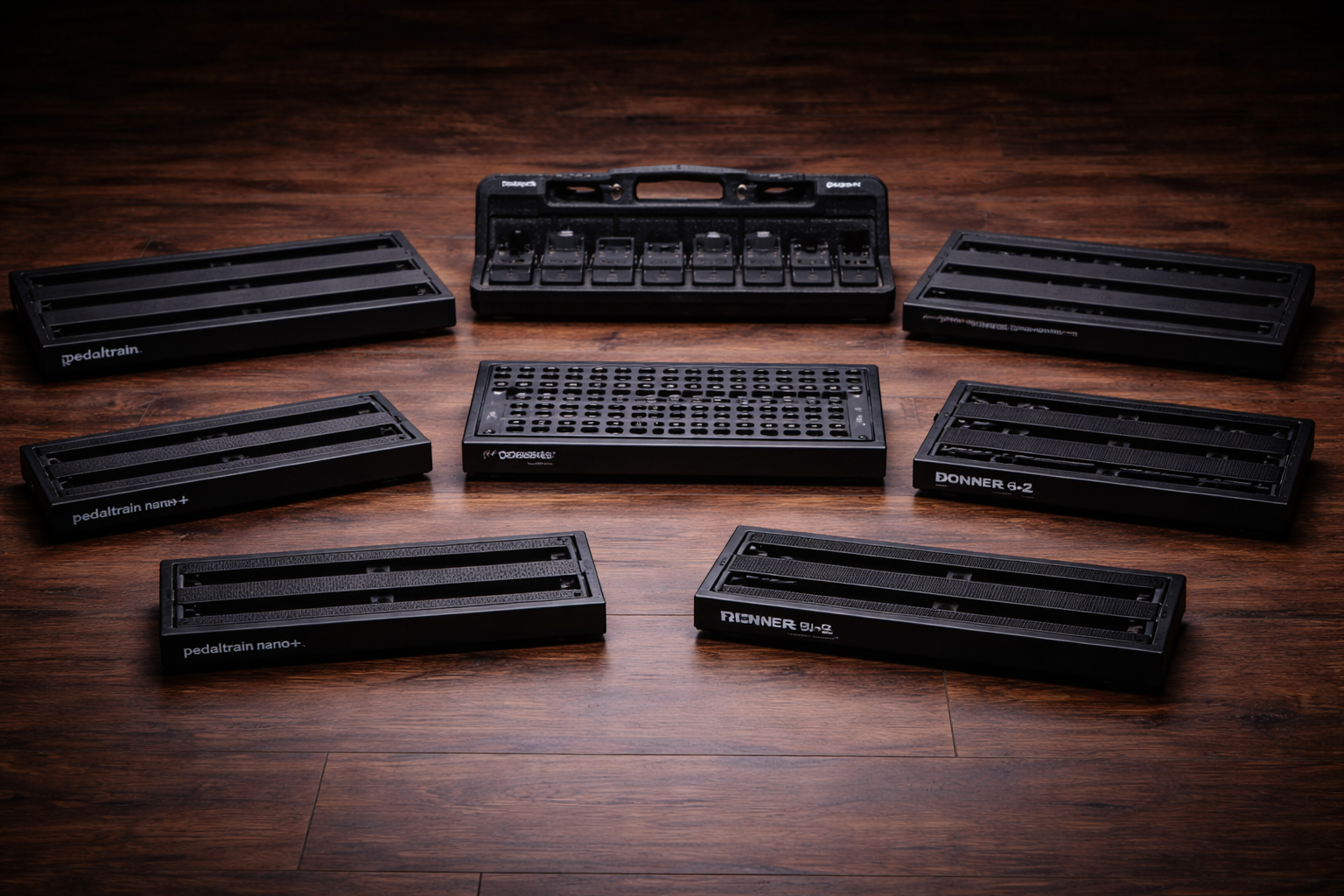 best pedalboard for guitar hero image: seven empty pedalboards in a dark studio setup