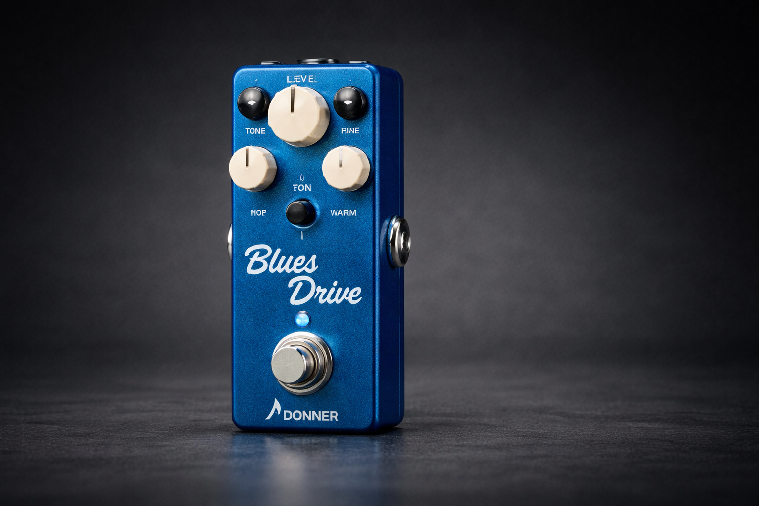 donner blues drive close-up on a clean dark background with knobs and footswitch in focus