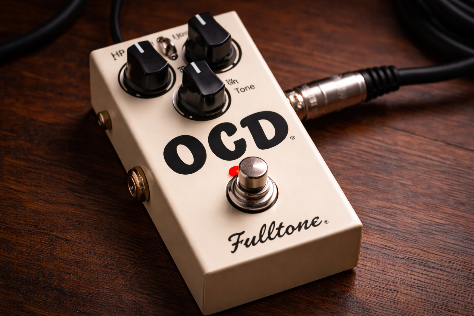 fulltone ocd review hero image: close-up of an OCD overdrive pedal on a wooden desk