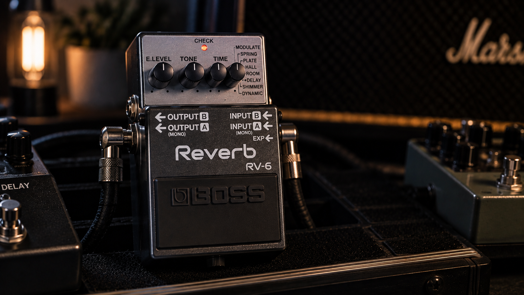 Boss RV-6 review image showing the compact reverb pedal in a dark studio rig.