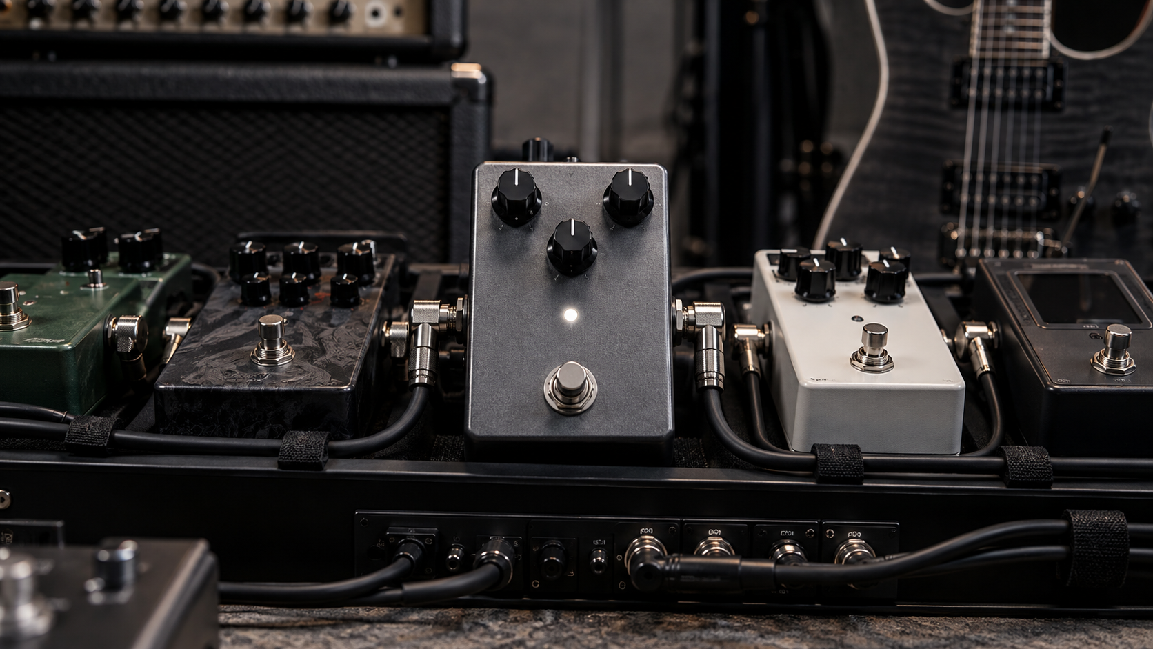 A guitar noise gate pedal shown on a pedalboard in a high-gain guitar setup