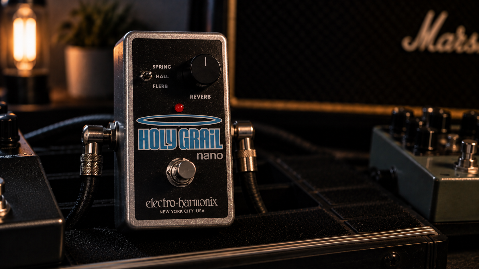 Holy Grail Nano review image showing the compact silver reverb pedal in a dark studio rig.