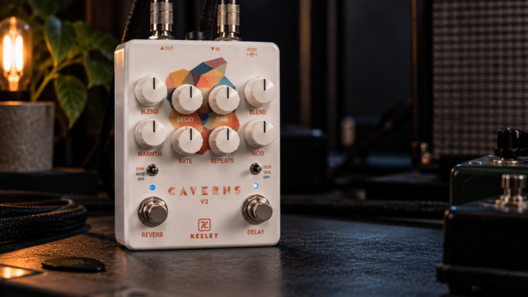 Keeley Caverns V2 review image showing the white delay and reverb pedal in a dark studio setup.